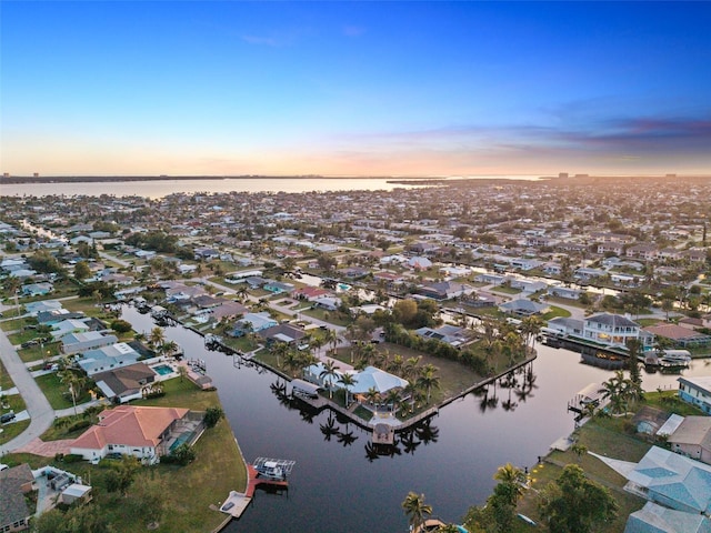 aerial view at dusk with a water view