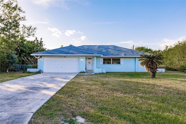 single story home with a garage and a front lawn