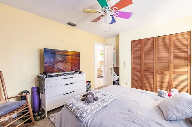 bedroom with light colored carpet, a closet, and ceiling fan