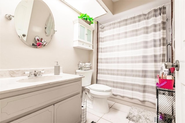 bathroom with tile patterned flooring, vanity, toilet, and walk in shower