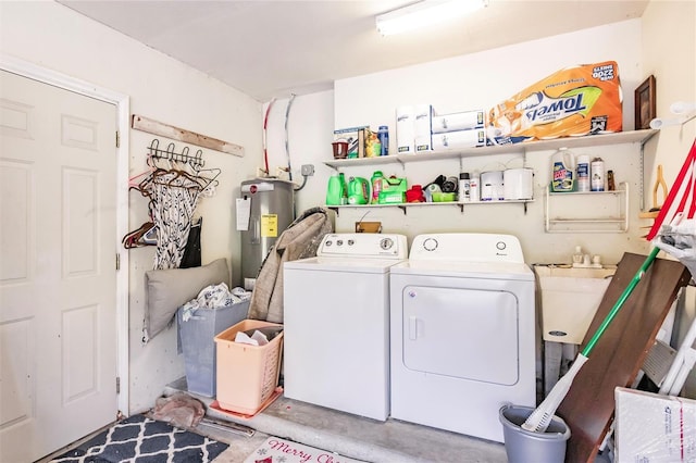 laundry area featuring sink, washer and clothes dryer, and water heater