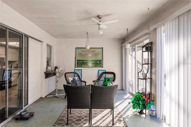 sunroom / solarium featuring ceiling fan