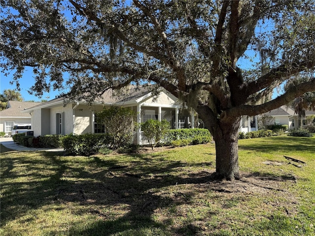 view of front of property with a front lawn and a sunroom