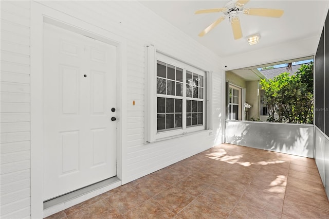 entrance to property featuring ceiling fan