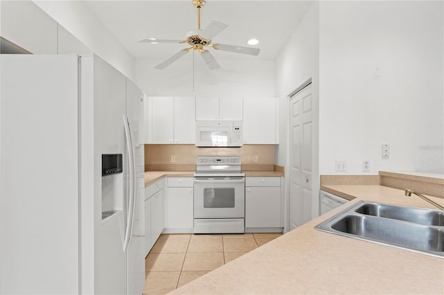 kitchen with sink, white cabinetry, light tile patterned floors, ceiling fan, and white appliances