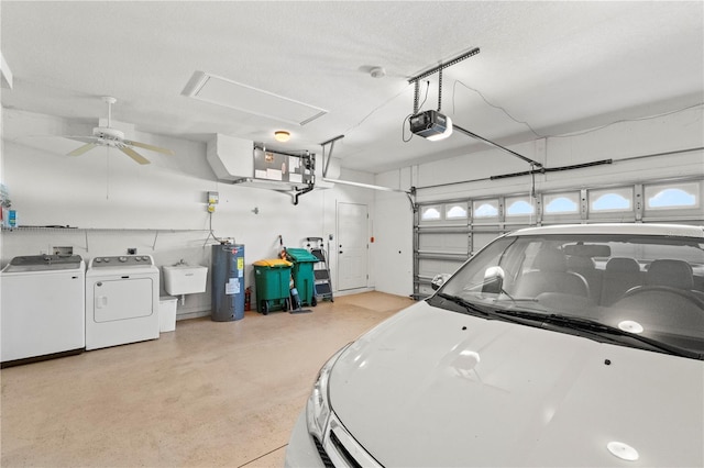 garage featuring sink, a garage door opener, washer and clothes dryer, ceiling fan, and electric water heater