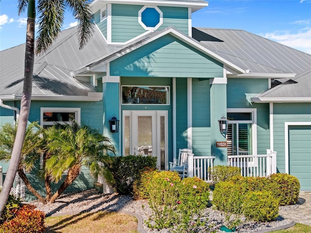 view of front of house with a porch and a garage