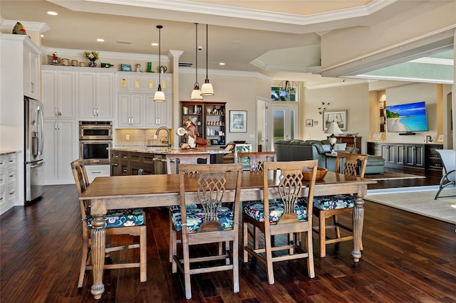 dining room with crown molding, sink, and dark hardwood / wood-style floors