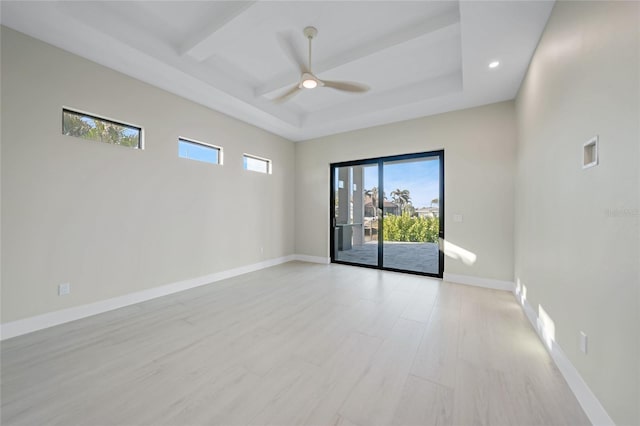 empty room with ceiling fan and light hardwood / wood-style floors