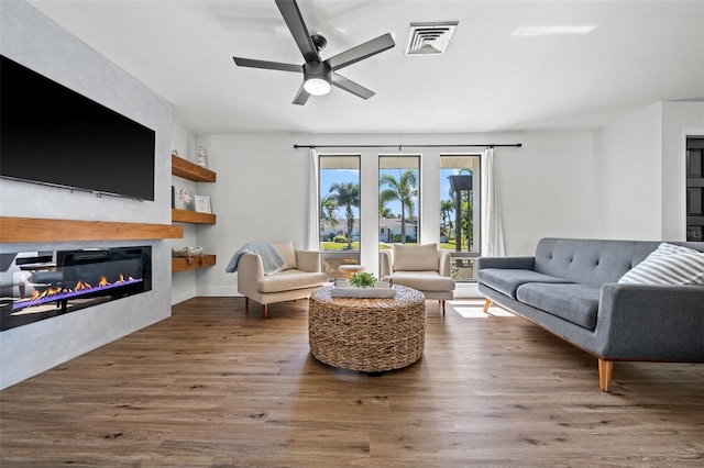 living room featuring hardwood / wood-style floors and ceiling fan