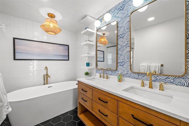 bathroom featuring vanity, a washtub, tile patterned floors, and tile walls