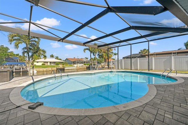 view of swimming pool featuring a water view, a patio, and glass enclosure