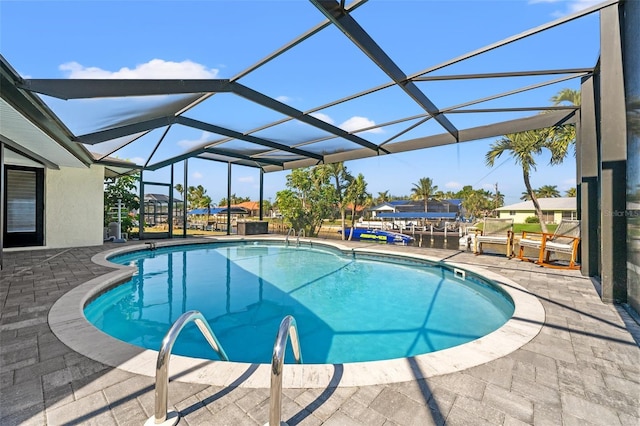 view of pool featuring a patio area and glass enclosure