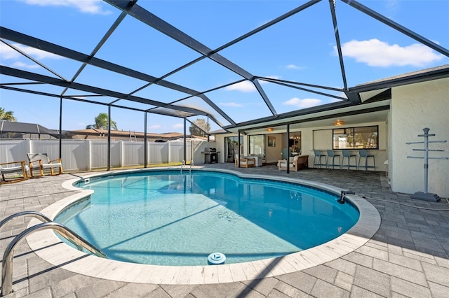 view of swimming pool with a lanai, an outdoor bar, and a patio