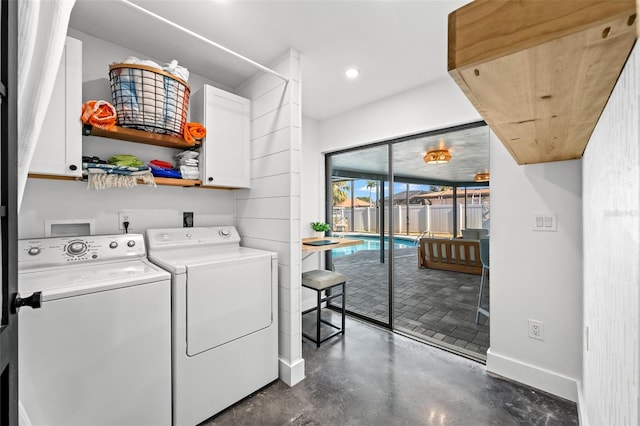 laundry area featuring cabinets and separate washer and dryer