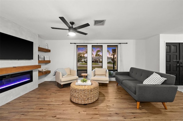 living room featuring hardwood / wood-style flooring and ceiling fan