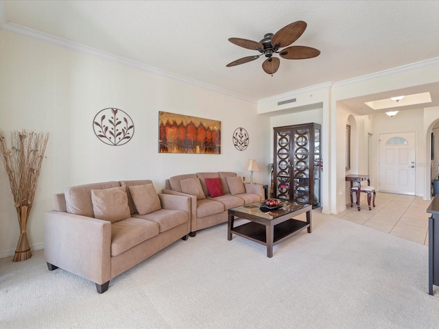 carpeted living room with crown molding and ceiling fan