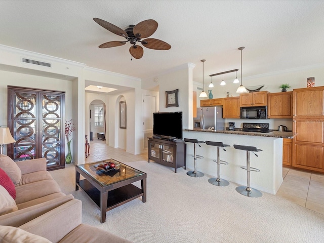 living room featuring crown molding, ceiling fan, light carpet, and a textured ceiling