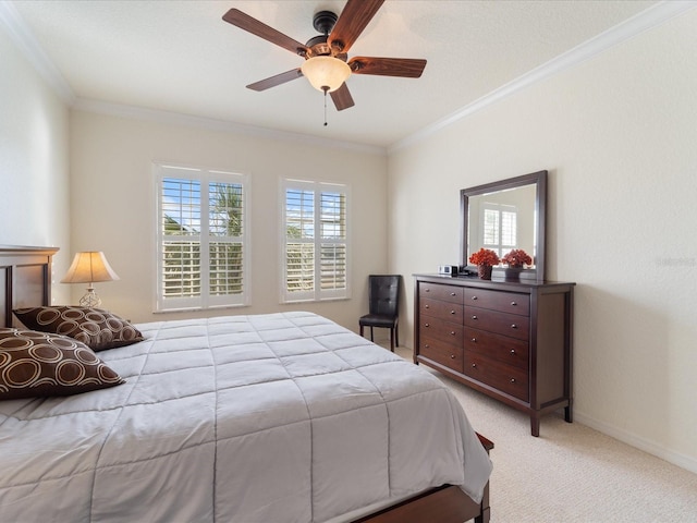 carpeted bedroom with ornamental molding and ceiling fan