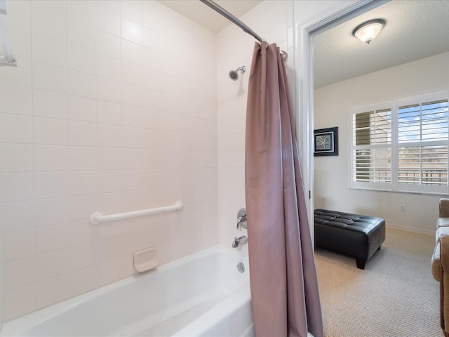 bathroom with a textured ceiling and shower / bath combo with shower curtain