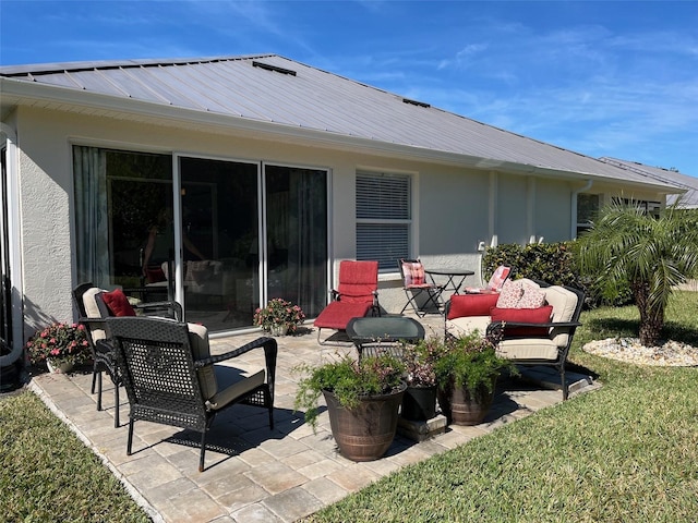 back of property featuring a yard and a patio