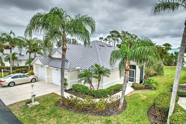 view of front of house featuring a garage and a front lawn