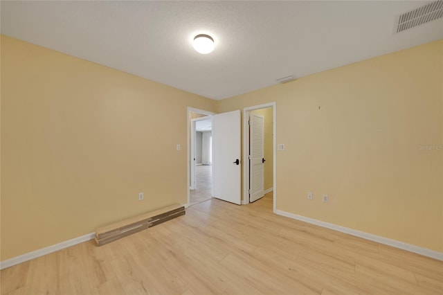 spare room with light hardwood / wood-style floors