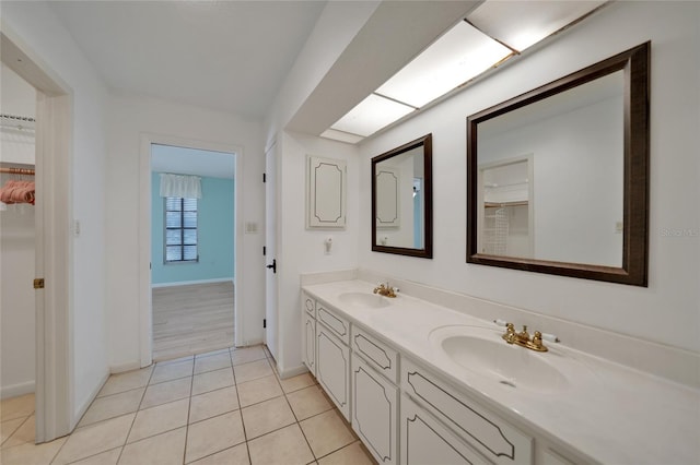 bathroom with tile patterned flooring and vanity