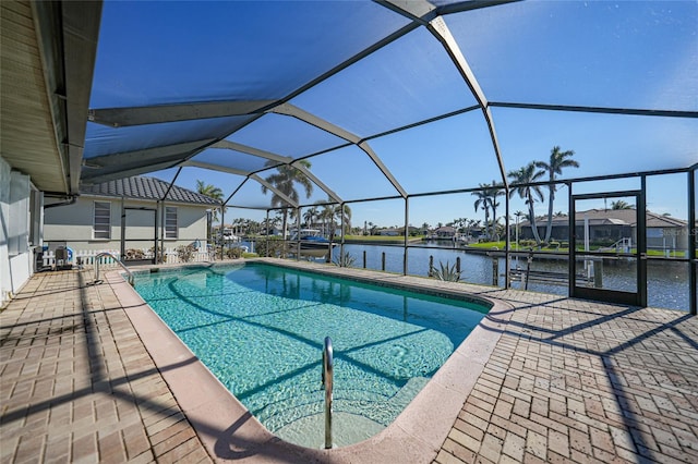 view of pool with a lanai, a patio area, and a water view