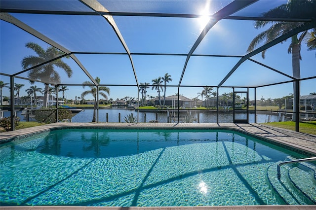 view of pool featuring a water view and glass enclosure