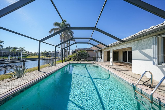 view of pool with a water view, a patio, and glass enclosure