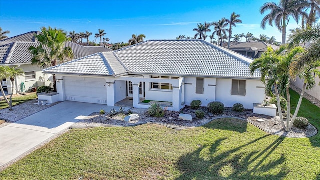 ranch-style home featuring a garage and a front lawn