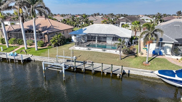 dock area with a water view, a yard, and a lanai