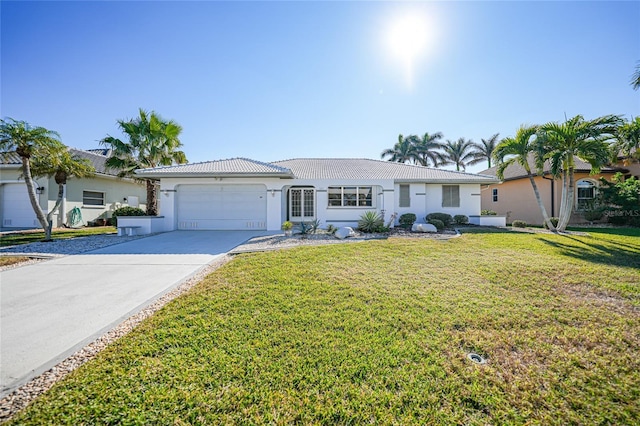 single story home with a garage and a front lawn