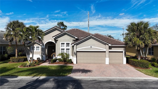 view of front of house with a garage and a front lawn