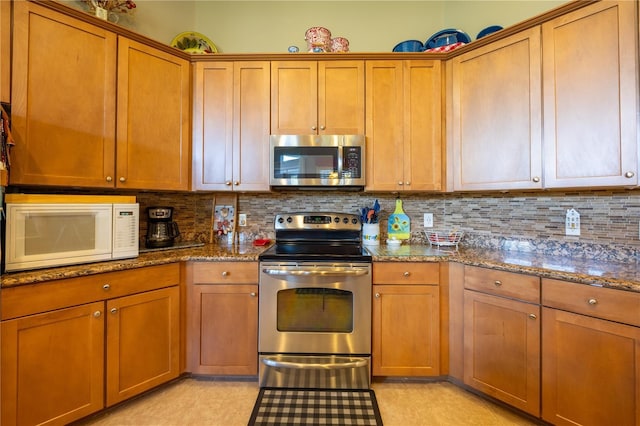 kitchen with dark stone countertops, decorative backsplash, and appliances with stainless steel finishes