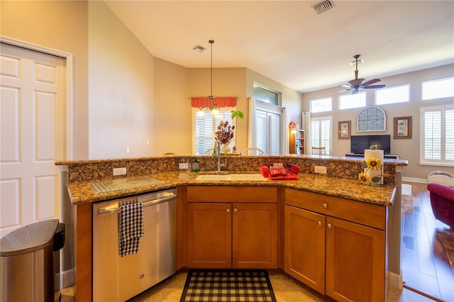 kitchen featuring a wealth of natural light, pendant lighting, sink, and stainless steel dishwasher