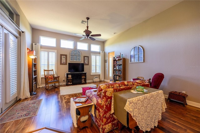 living room with dark wood-type flooring and ceiling fan