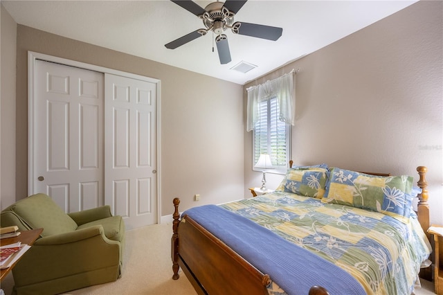 carpeted bedroom featuring a closet and ceiling fan