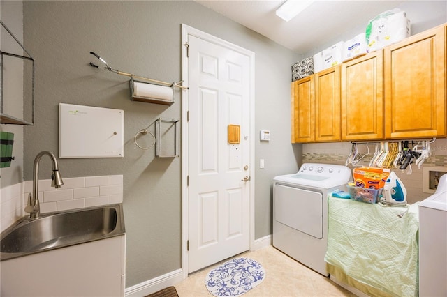 washroom with cabinets, washer and dryer, sink, and light tile patterned floors