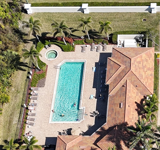 view of swimming pool with a hot tub