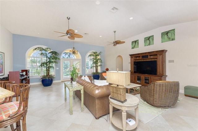 living room with lofted ceiling, ceiling fan, and a healthy amount of sunlight