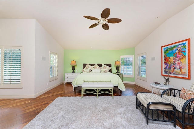 bedroom featuring ceiling fan, lofted ceiling, and dark hardwood / wood-style flooring