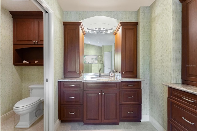 bathroom featuring tile patterned floors, toilet, and vanity