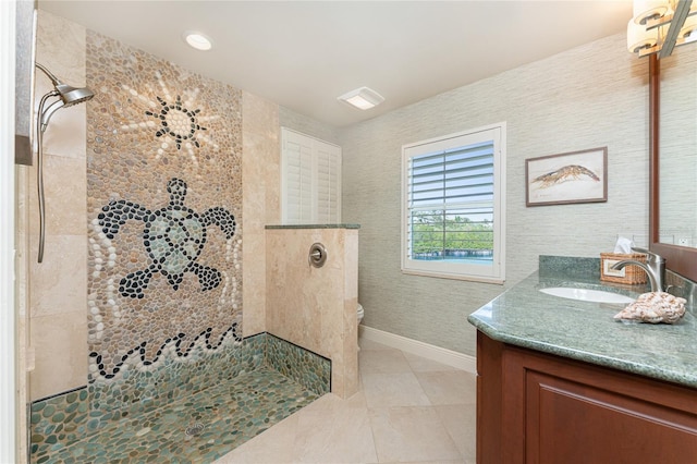 bathroom featuring tiled shower, vanity, toilet, and tile patterned floors