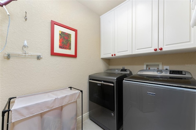 washroom featuring cabinets and independent washer and dryer