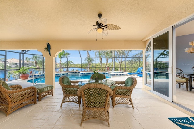 sunroom / solarium featuring a pool, plenty of natural light, and ceiling fan