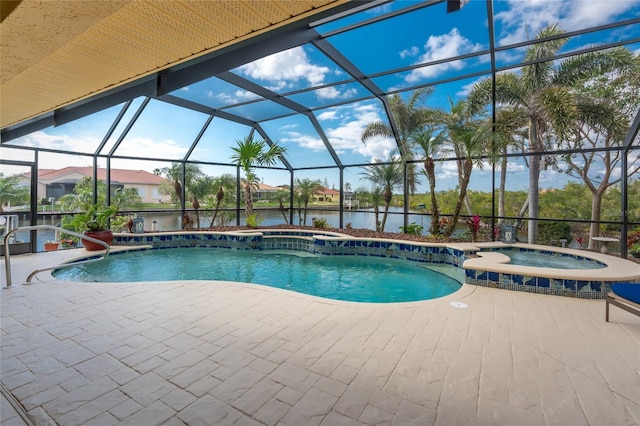 view of swimming pool featuring an in ground hot tub, a water view, a patio area, and glass enclosure