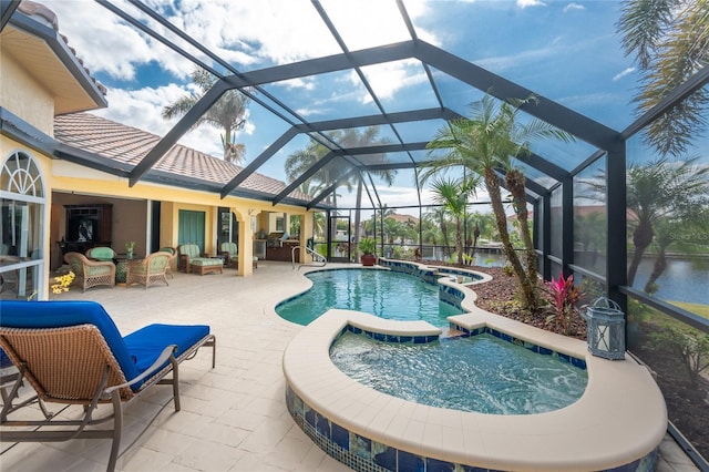 view of pool featuring outdoor lounge area, a patio, a water view, glass enclosure, and an in ground hot tub