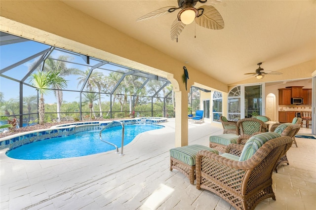 view of swimming pool featuring a lanai, a patio, and ceiling fan